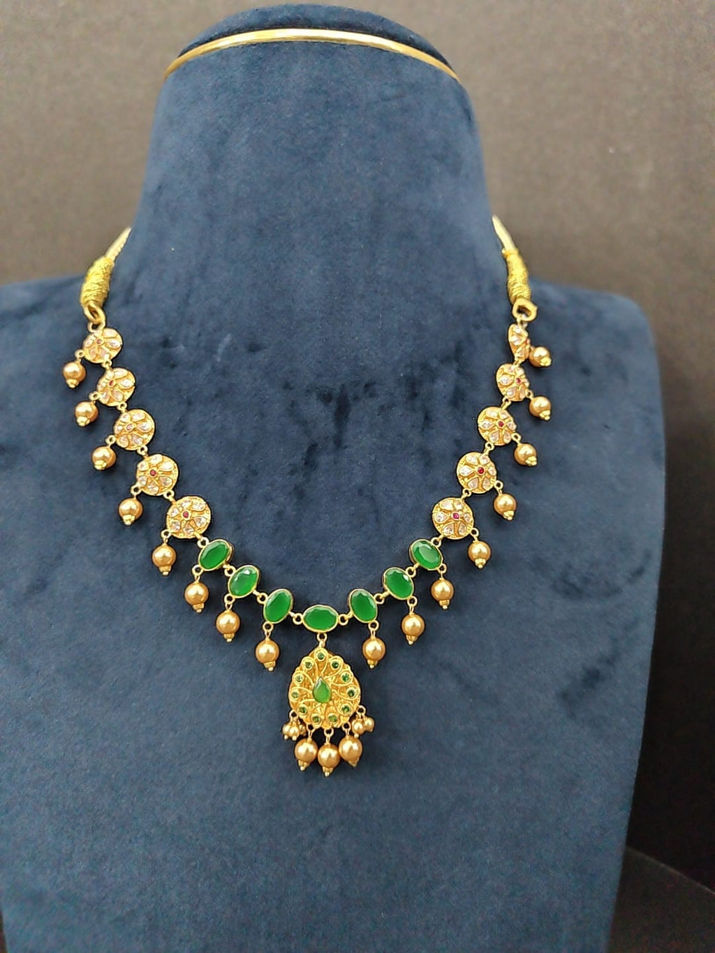 N78 emerald side: flower motifs, emerald-green stones, leaf pendant and gold drops